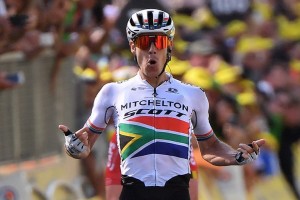 South Africa's Daryl Impey celebrates as he wins on the finish line of the ninth stage of the 106th edition of the Tour de France cycling race between Saint-Etienne and Brioude, in Brioude, eastern France, on July 14, 2019. (Photo by Marco Bertorello / AFP)